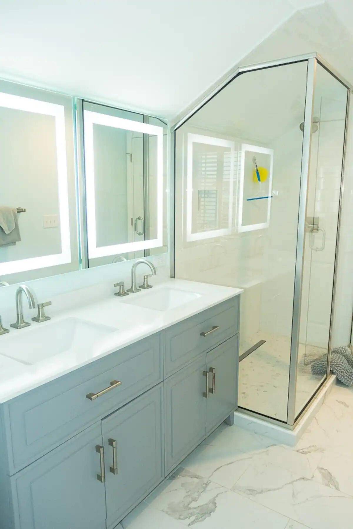 Bathroom with double sinks and walk-in shower