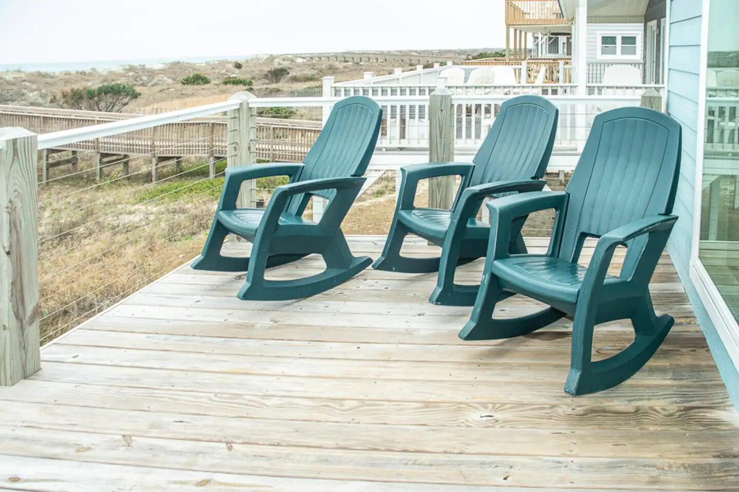 Rocking chairs on the deck looking toward the dunes